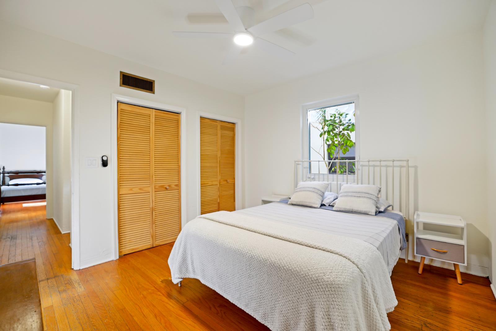 Main bedroom with bed wall and closet doors