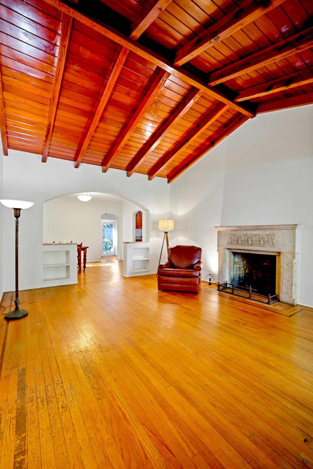 Living room angle highlighting the wood ceiling and natural light