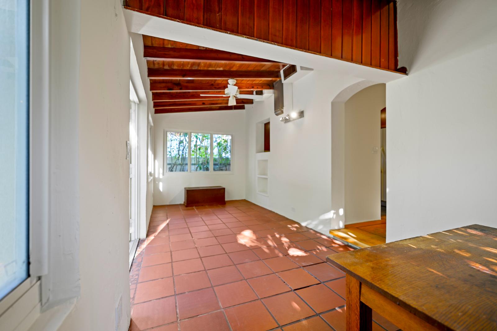 Sunroom showing vaulted wood ceiling and light-filled interior