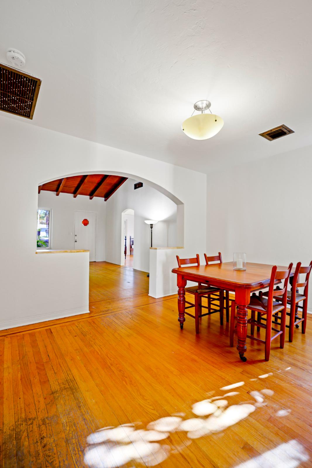 Vertical dining room angle with hardwood floors and bright natural light