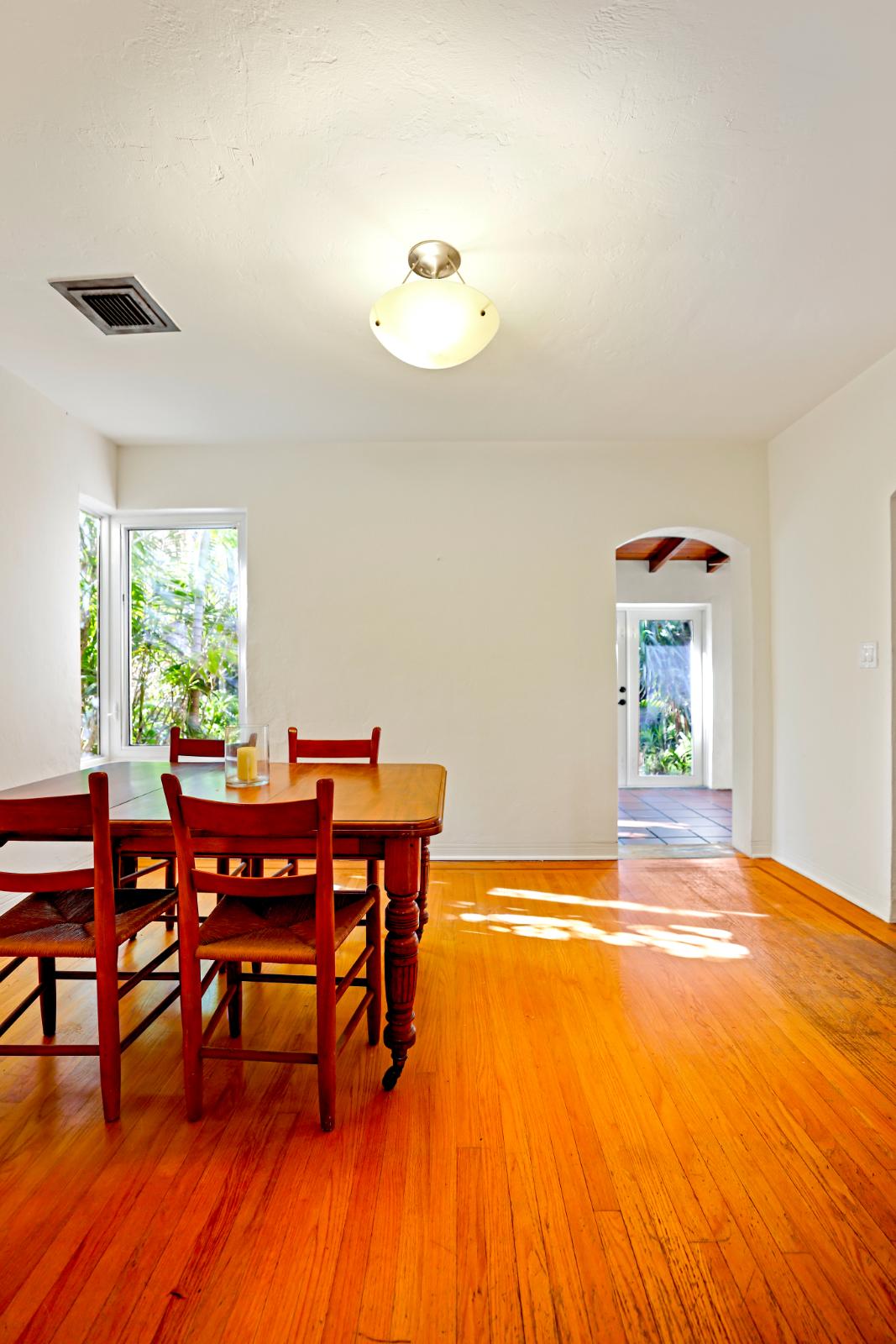 Dining area view showing warm finishes and adjacent circulation